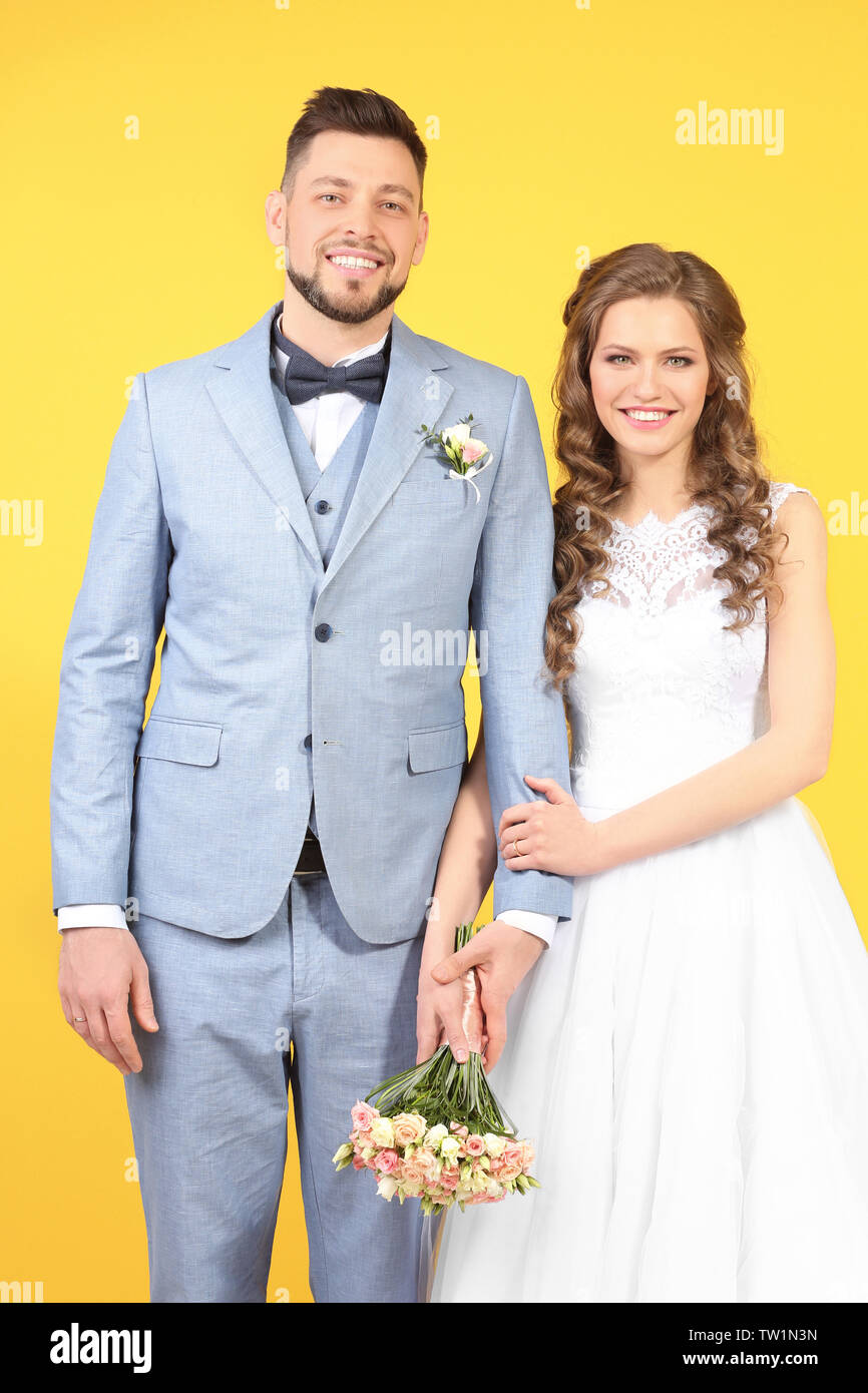 Happy wedding couple on color background Stock Photo - Alamy