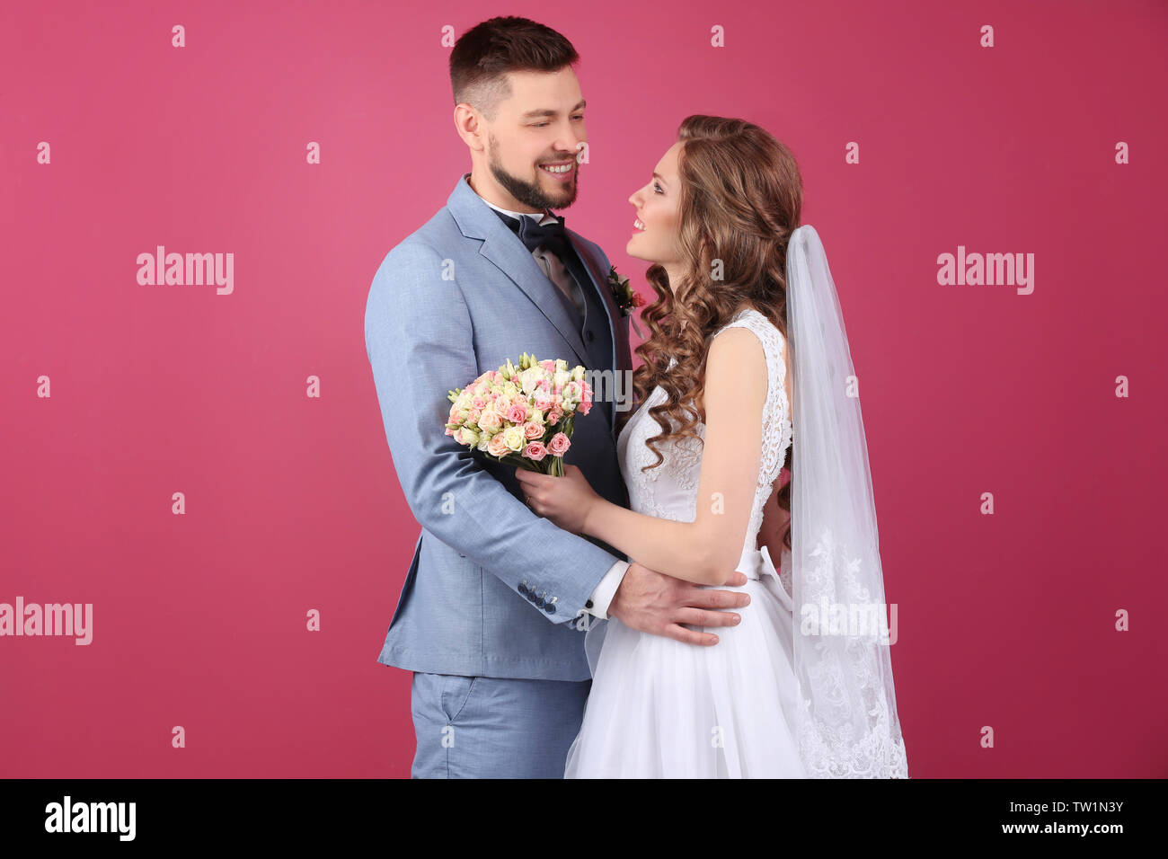 Happy wedding couple on color background Stock Photo - Alamy