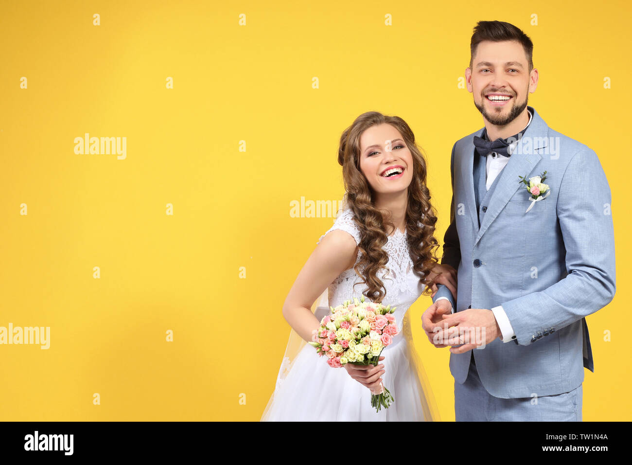 Happy wedding couple on color background Stock Photo - Alamy