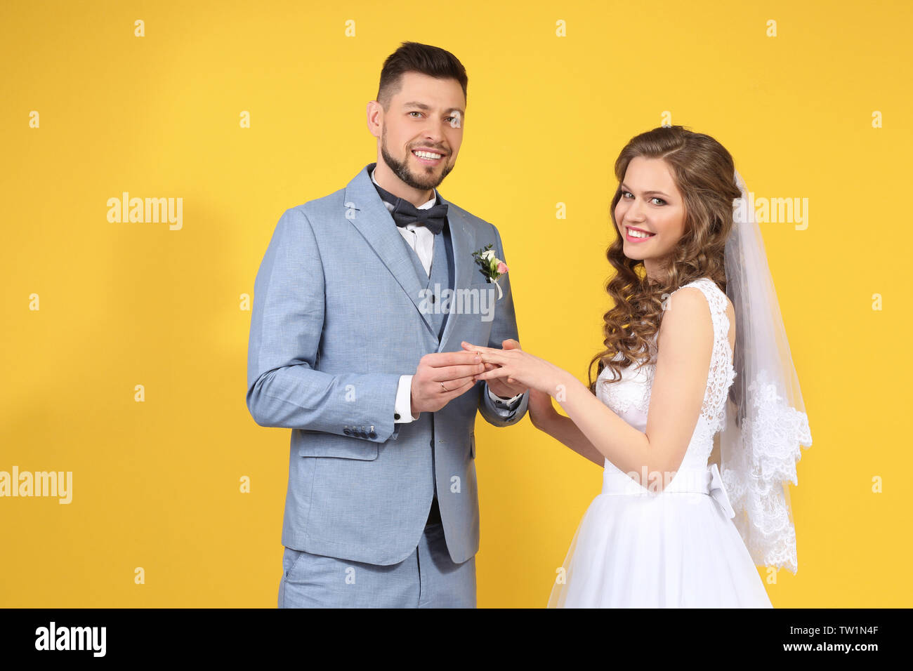 Happy wedding couple on color background Stock Photo - Alamy