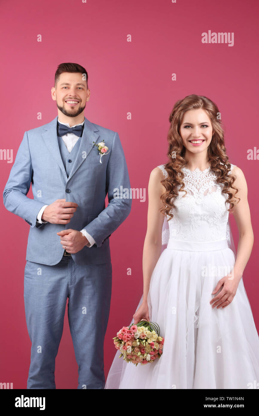 Happy wedding couple on color background Stock Photo - Alamy