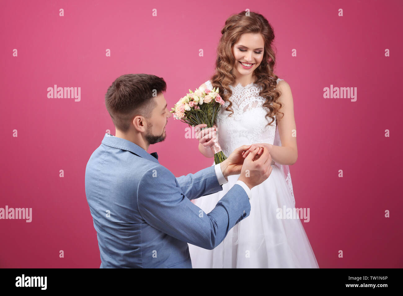 Happy wedding couple on color background Stock Photo - Alamy