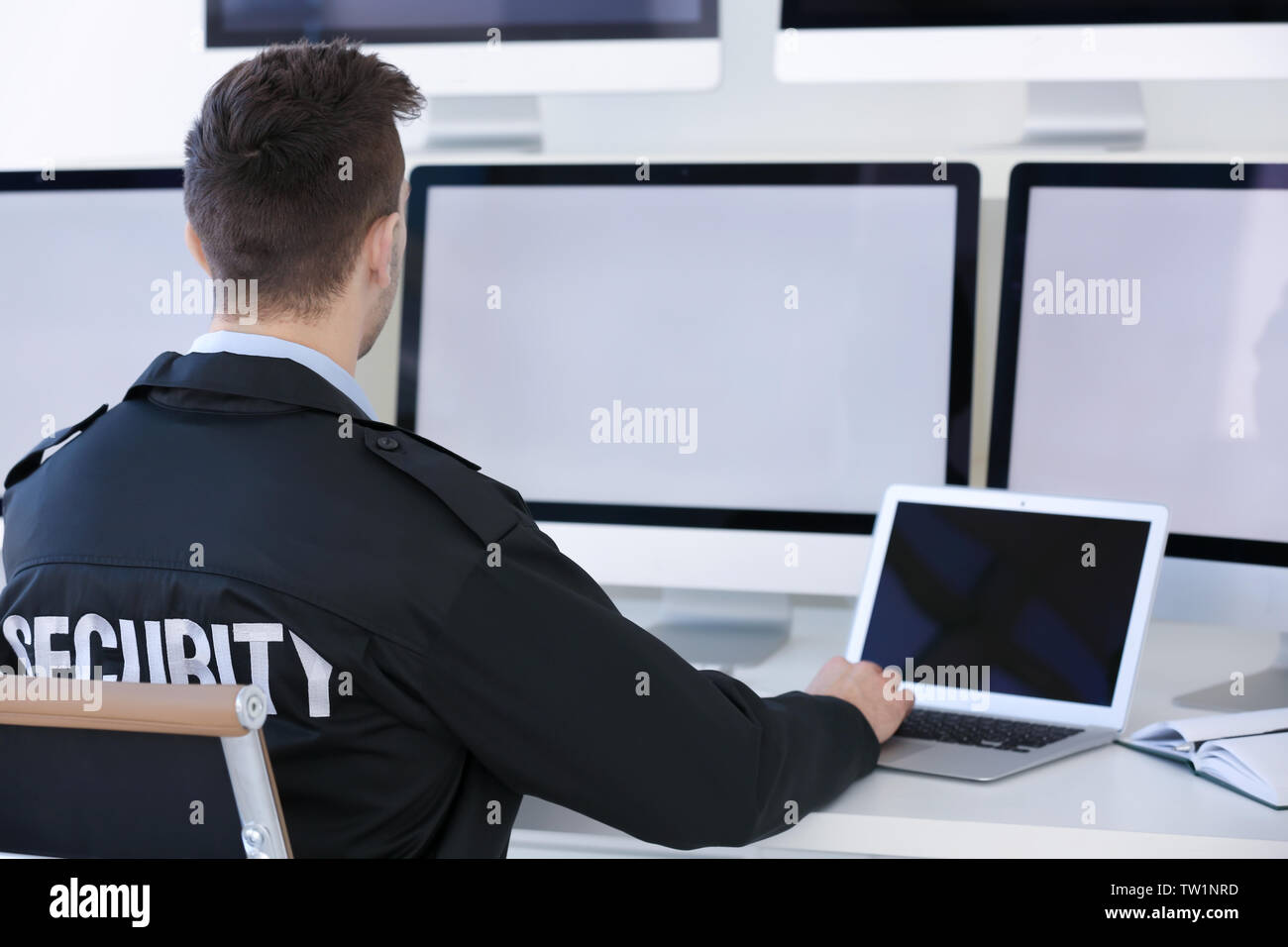 Handsome security guard in surveillance room Stock Photo - Alamy