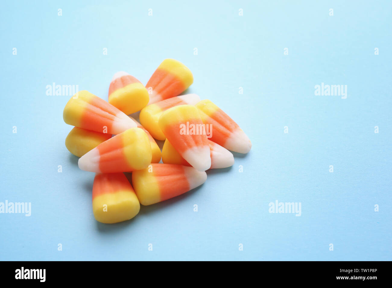 Colorful Halloween candy corns on blue background Stock Photo - Alamy