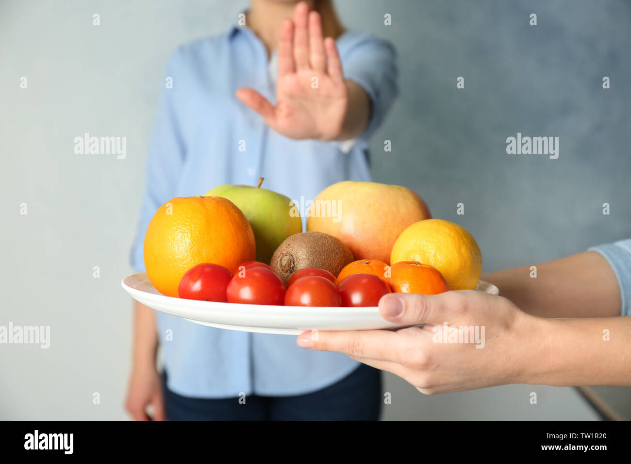 Allergy concept. Young woman refusing to eat fruits and vegetable Stock