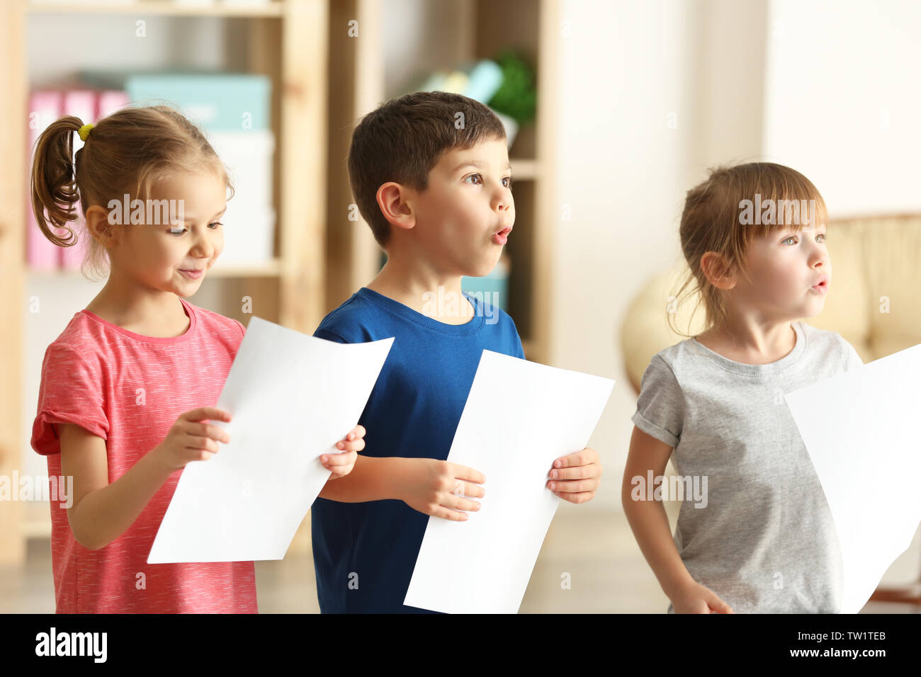Cute kids singing in music class Stock Photo