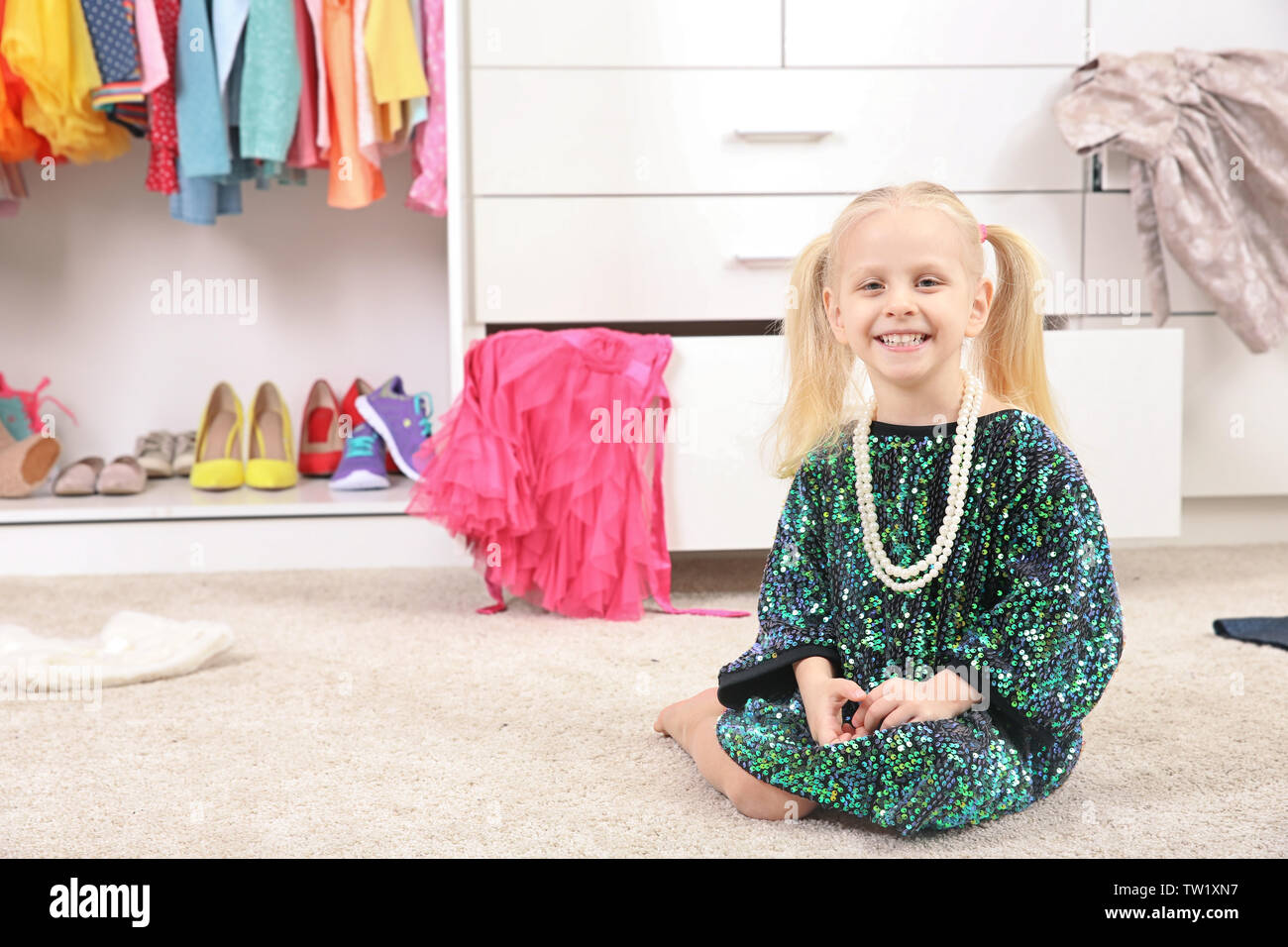 Cute fashion girl sitting on floor Stock Photo - Alamy