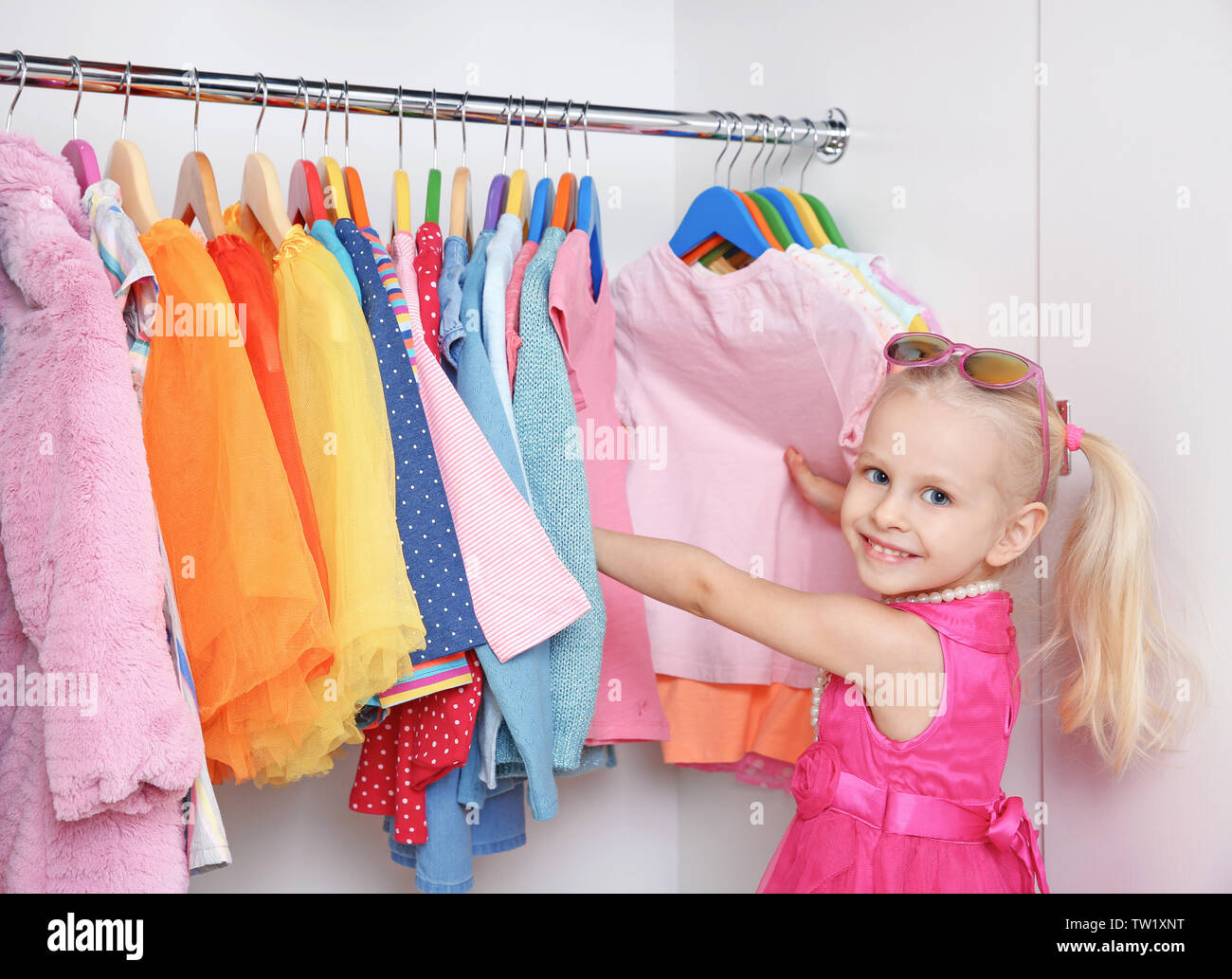 Cute Small Girl In Wardrobe With Clothes Stock Photo 256354500