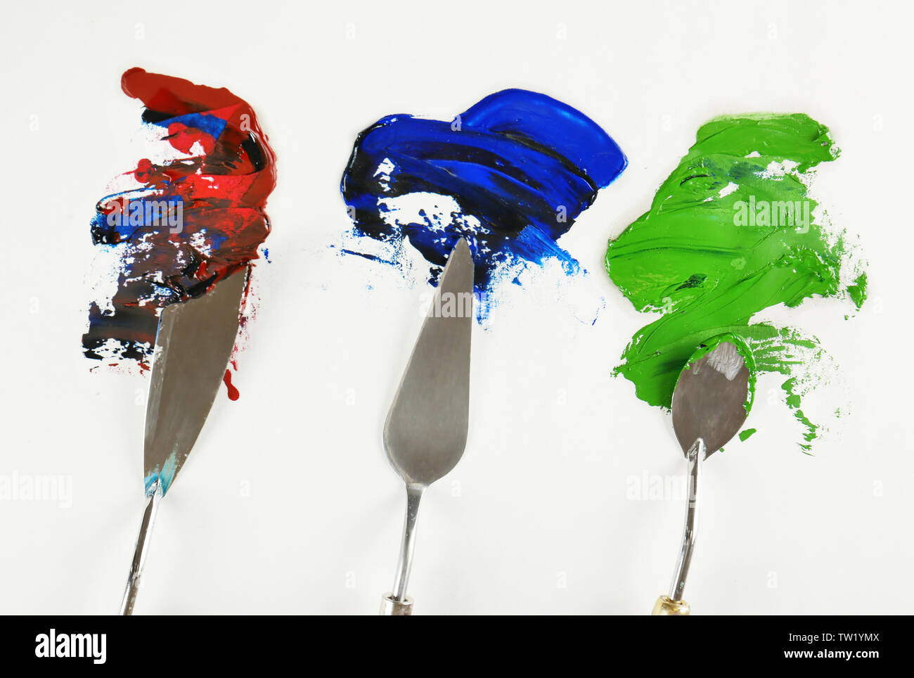 Palette knives with paint on paper Stock Photo Alamy
