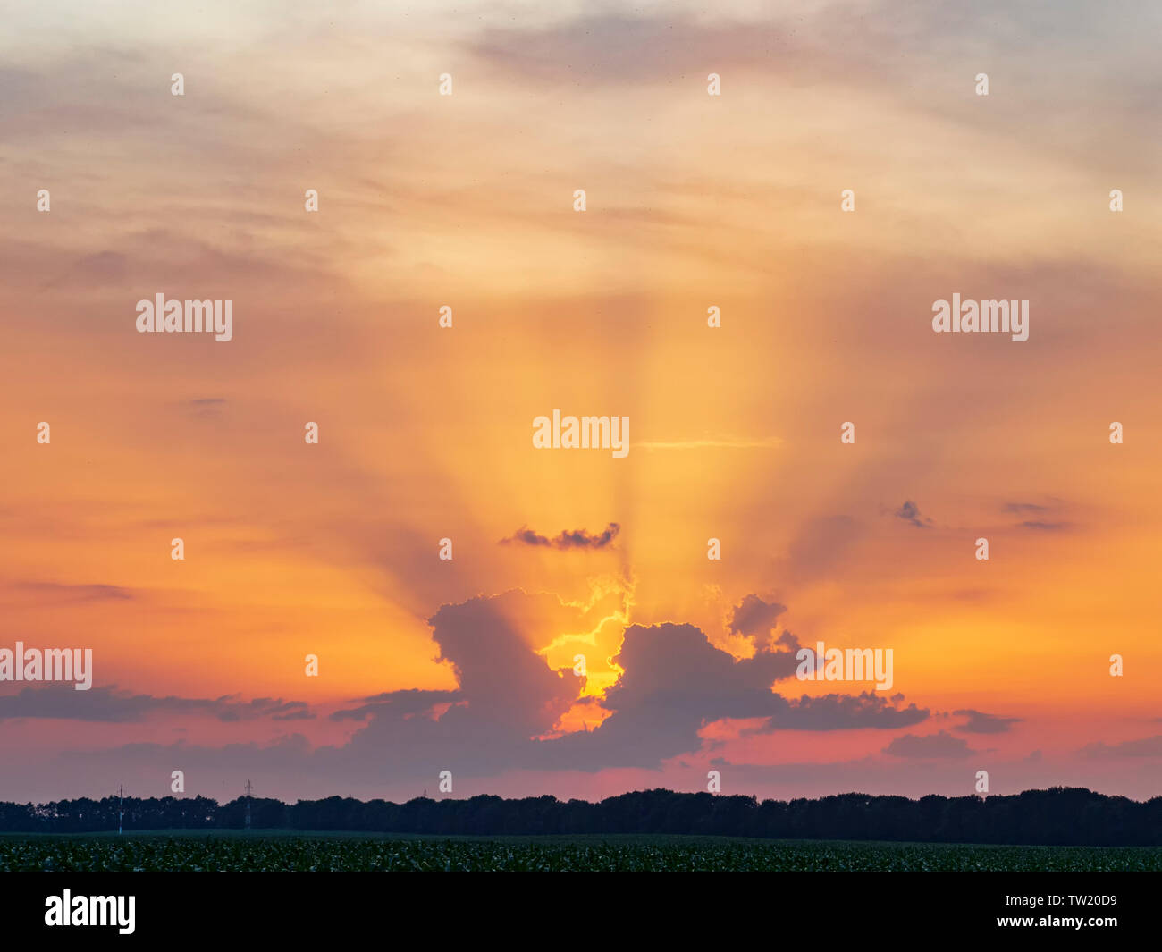 Colorful sunset with sun beams. Dramatic evening clouds Stock Photo
