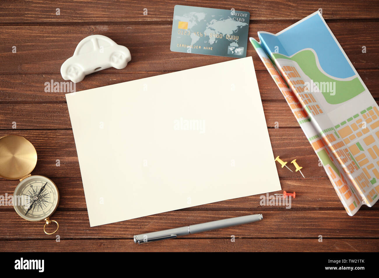 Blank notepad page, credit card and travel accessories on wooden background Stock Photo