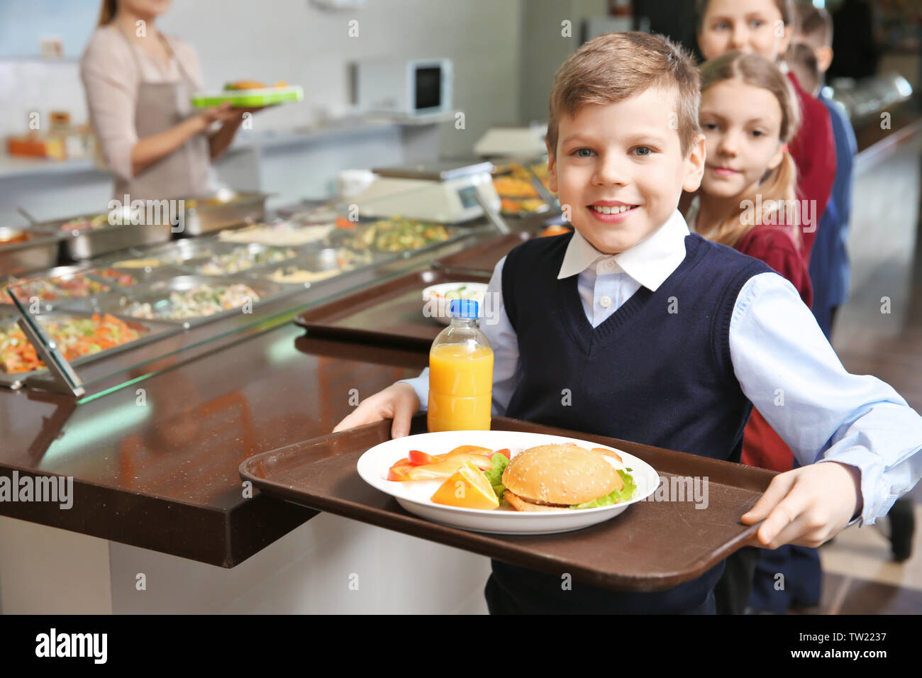 https://c8.alamy.com/comp/TW2237/cute-girl-holding-tray-with-delicious-food-in-school-cafeteria-TW2237.jpg