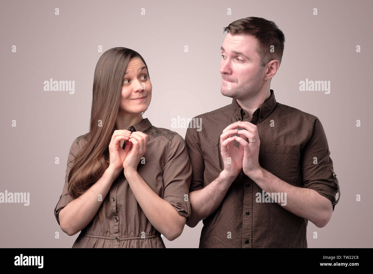 Young couple with insidious and grinning faces smile. Stock Photo