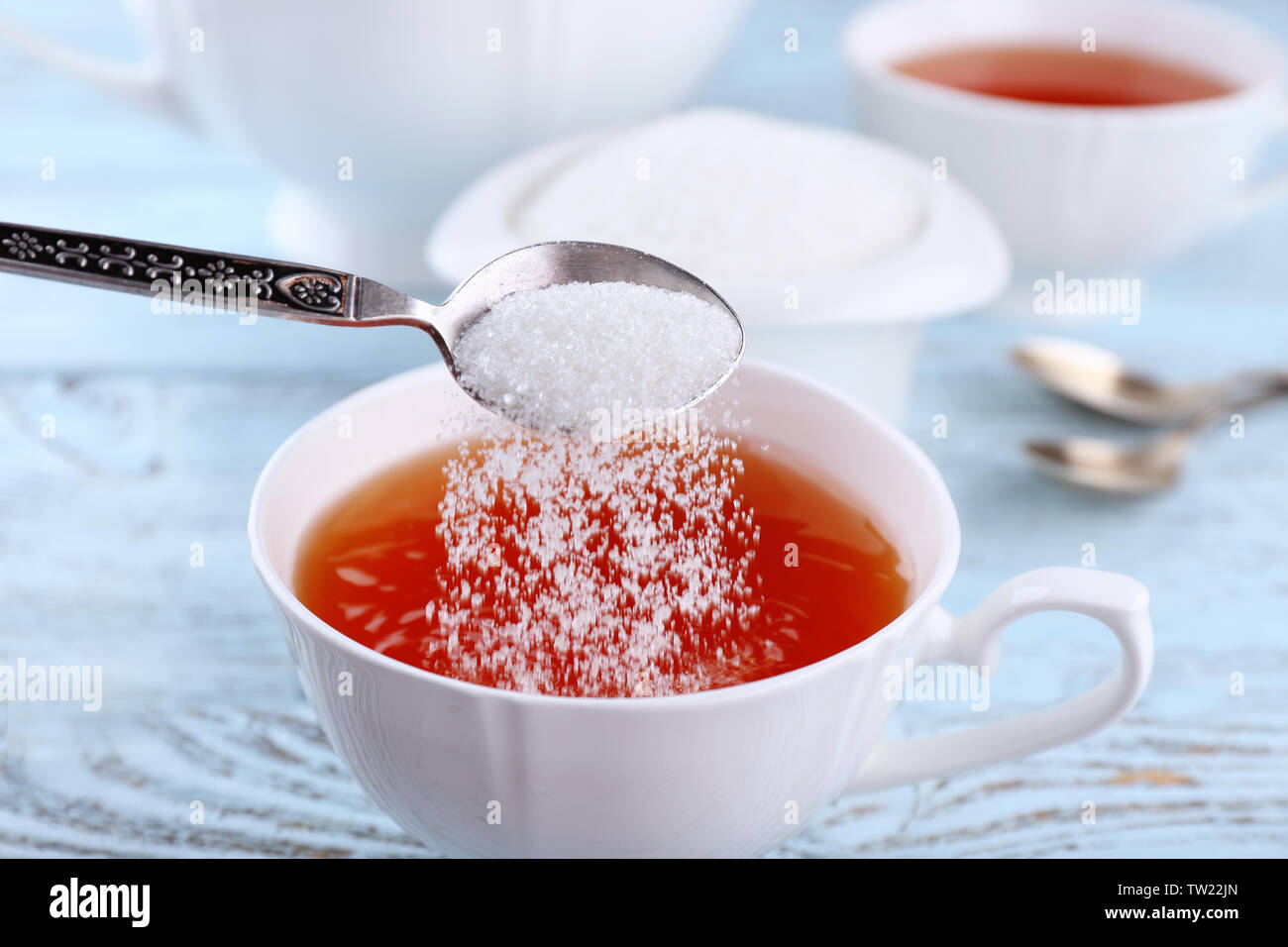 Sugar spoon tea adding hires stock photography and images Alamy