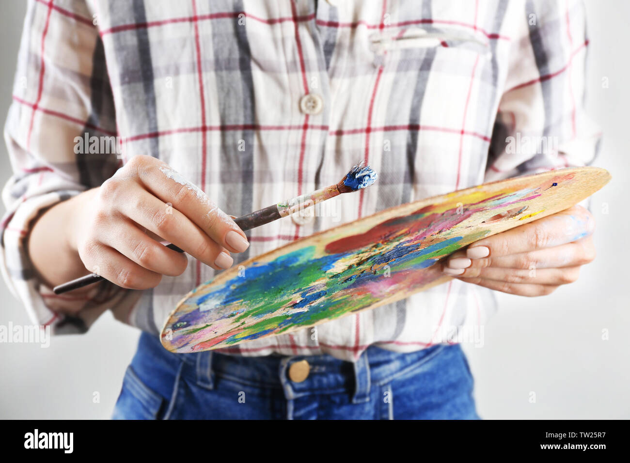Woman holding palette of oil paints and painting brush, closeup Stock ...