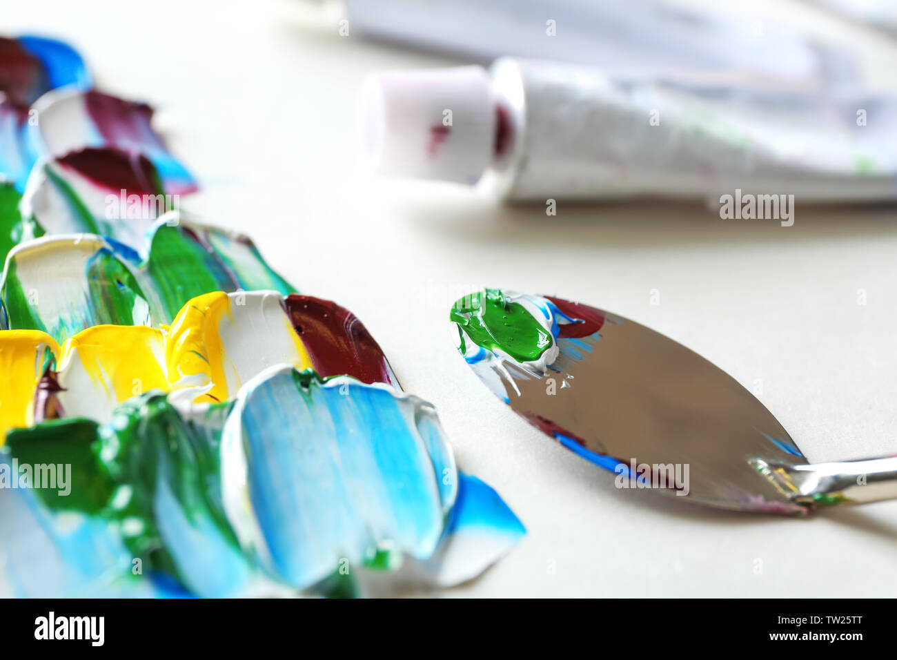 Colorful paints, palette knife and used tube, closeup Stock Photo Alamy