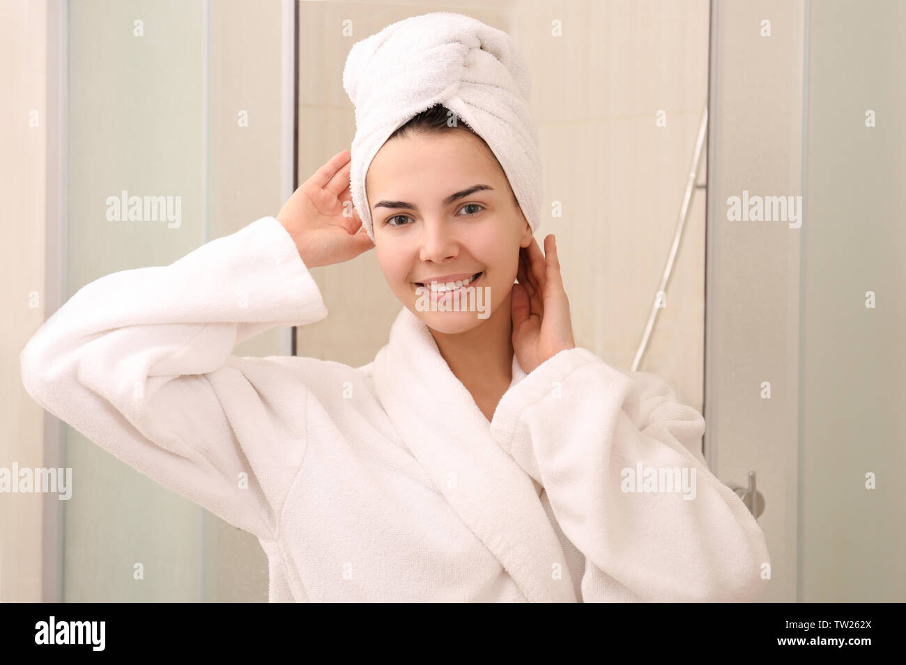Beautiful young woman wearing bathrobe in shower Stock Photo Alamy