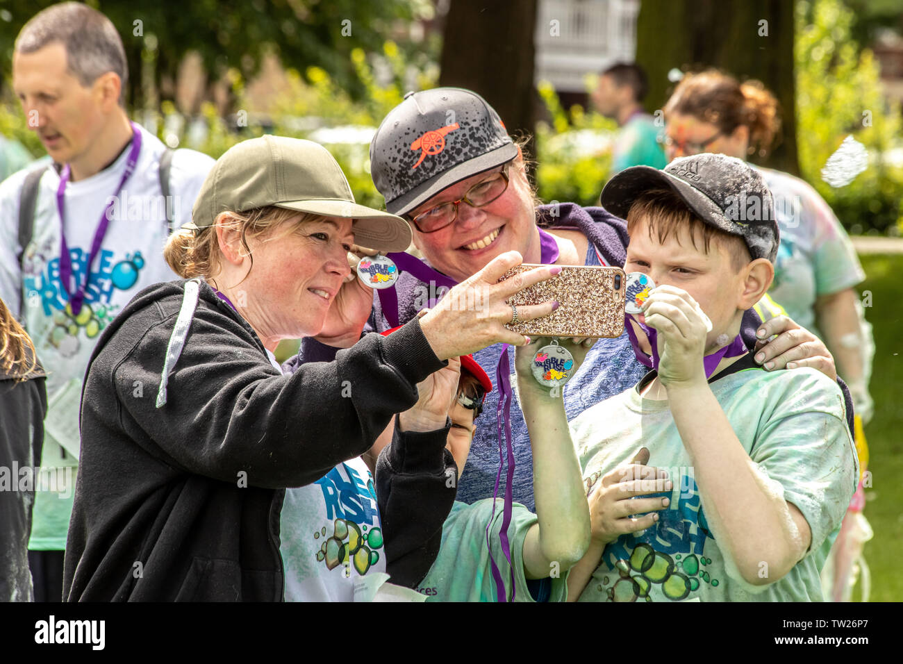 Showing off winners medals after the Kings Lynn Bubble Rush 5k run. Stock Photo