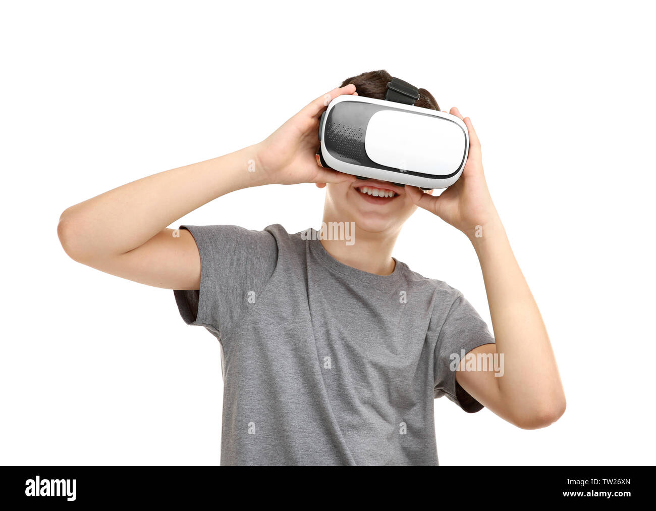 Portrait of boy having fun with virtual reality headset on white ...
