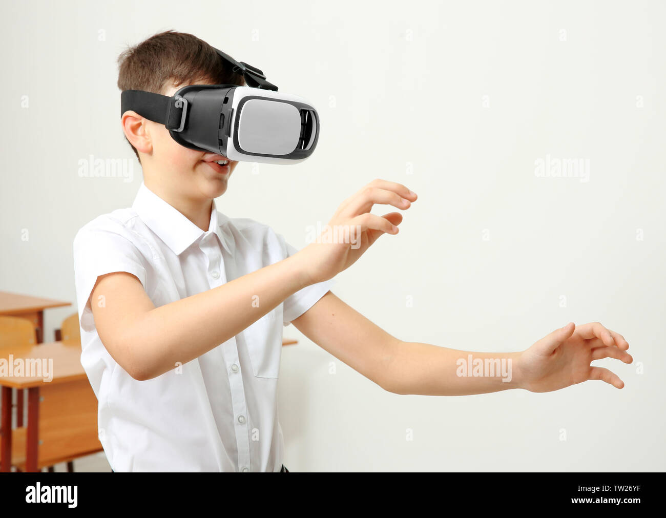 Boy having fun with virtual reality headset in classroom Stock Photo ...