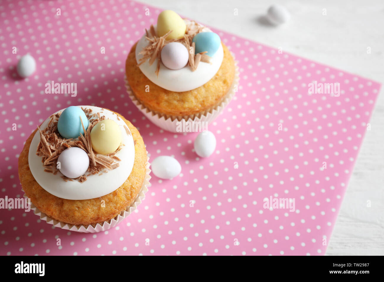 Delicious Easter cupcakes on white table Stock Photo