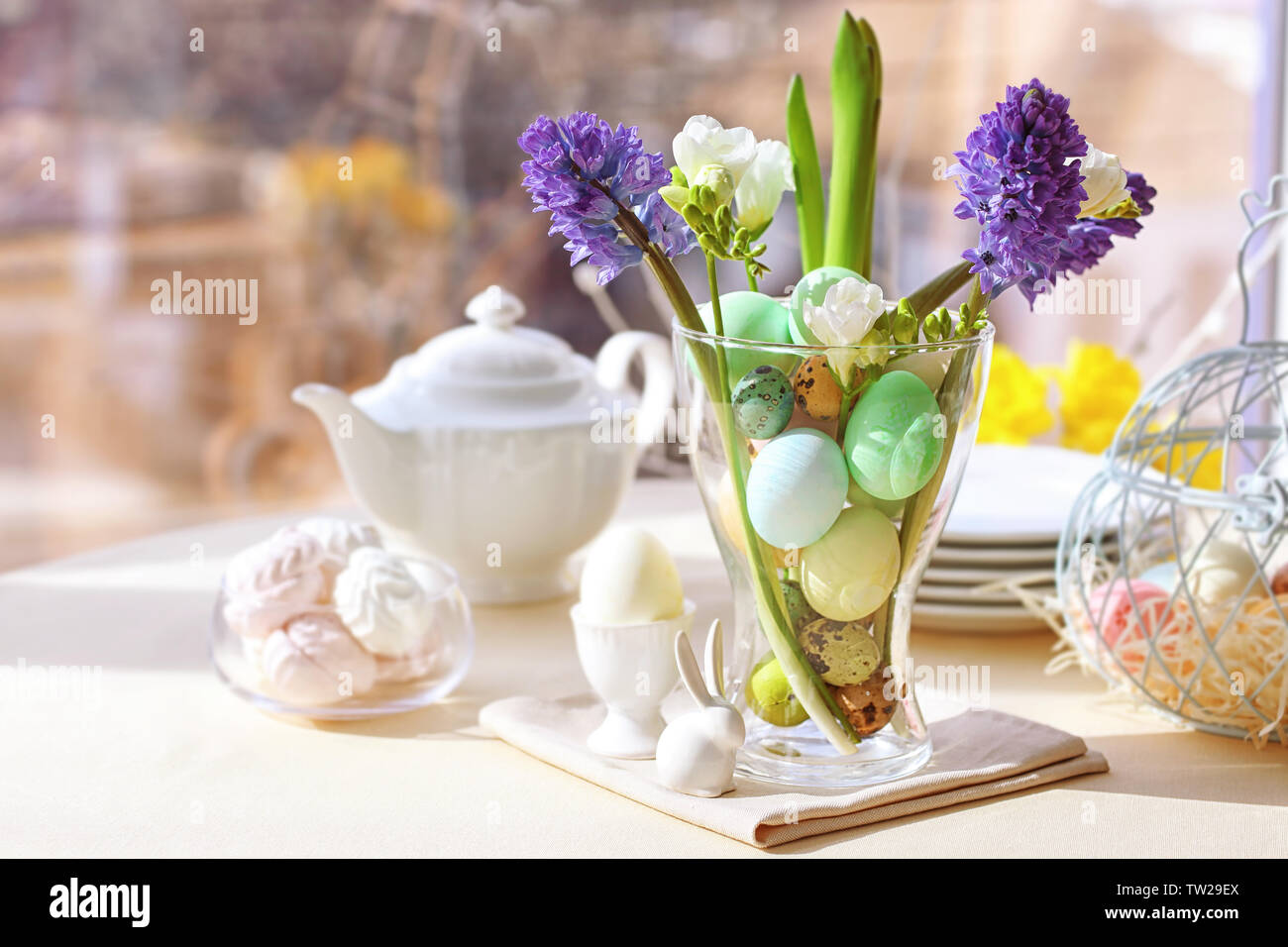 Beautiful Easter pastel decorations with table setting on blurred background Stock Photo