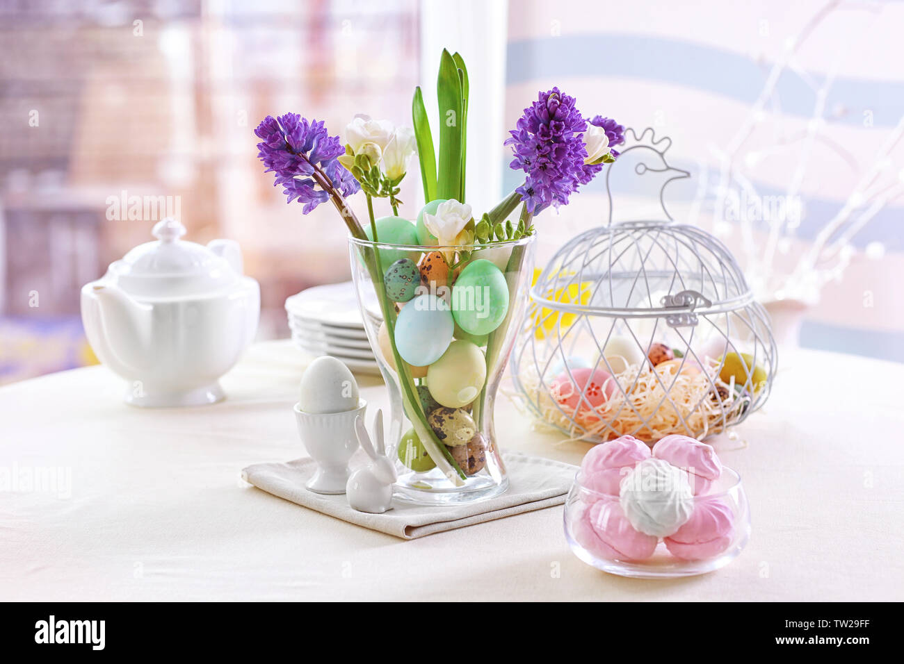 Beautiful Easter pastel decorations with table setting on blurred background Stock Photo