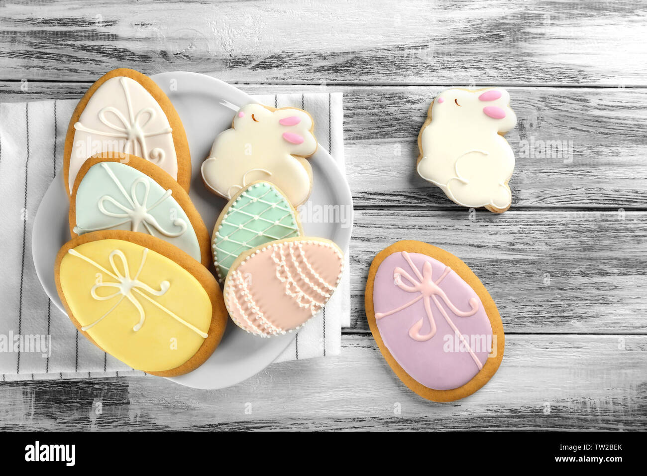 Beautiful glazed Easter cookies on wooden table Stock Photo