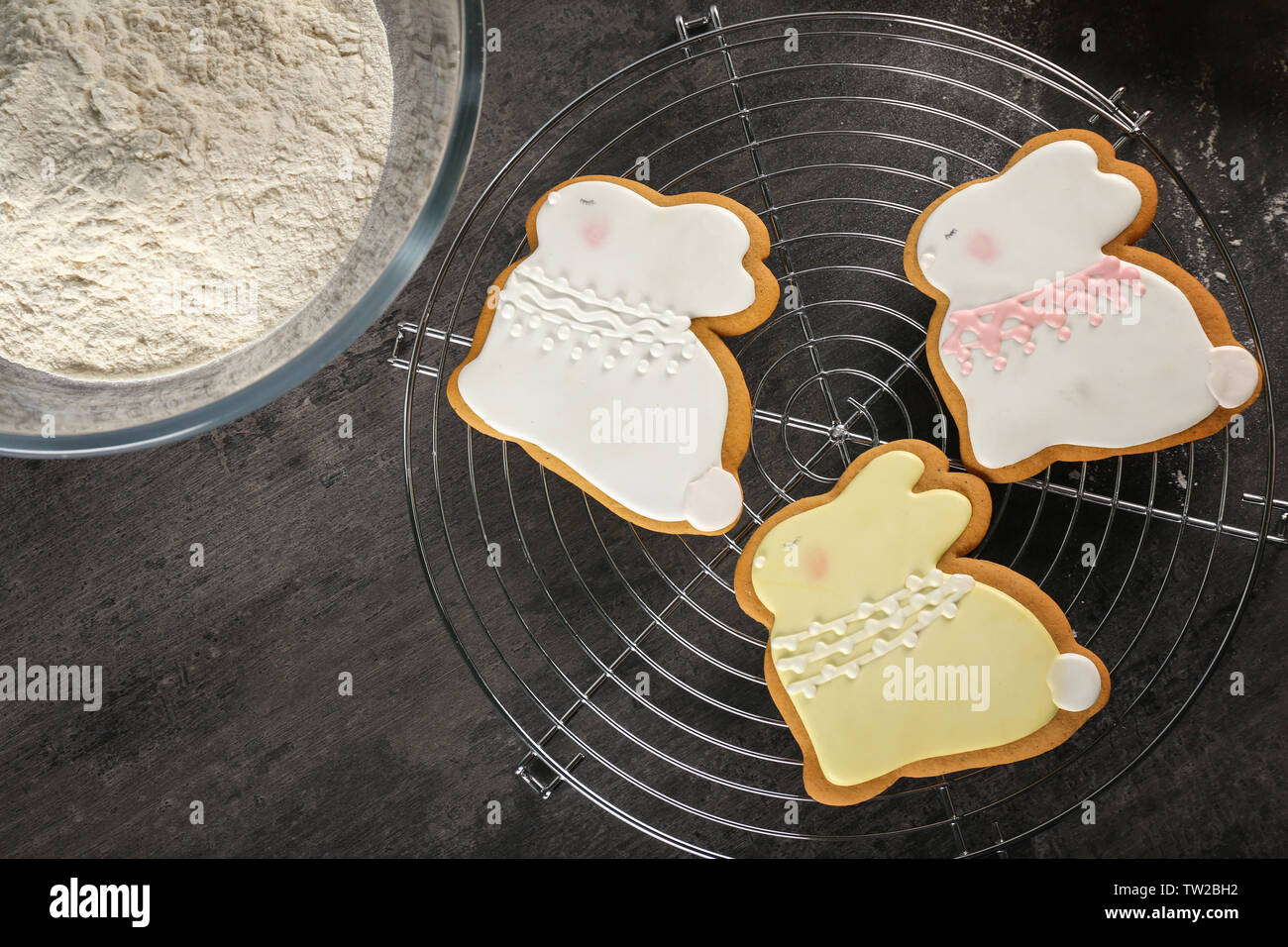 Beautiful glazed Easter cookies on cooling rack Stock Photo