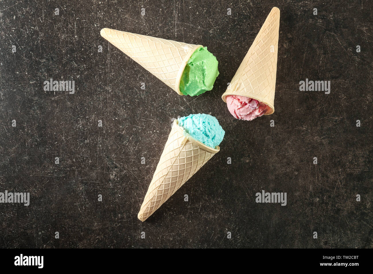 Waffle cones with colorful ice cream on table Stock Photo