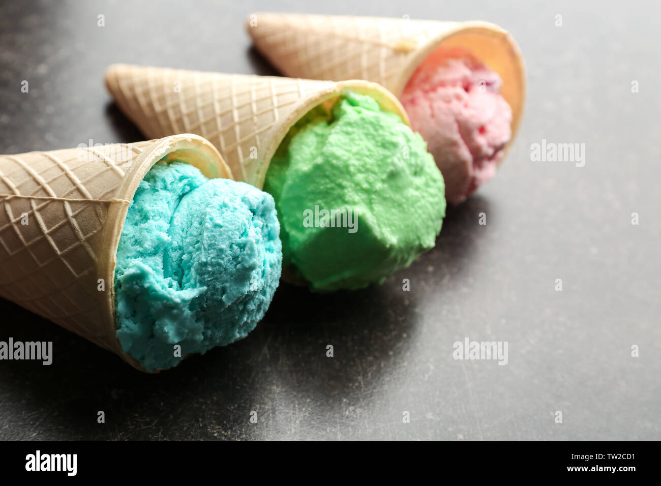 Waffle cones with colorful ice cream on table Stock Photo