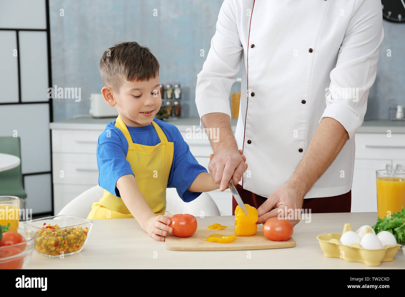 Father and son cooking together in kitchen Stock Photo - Alamy
