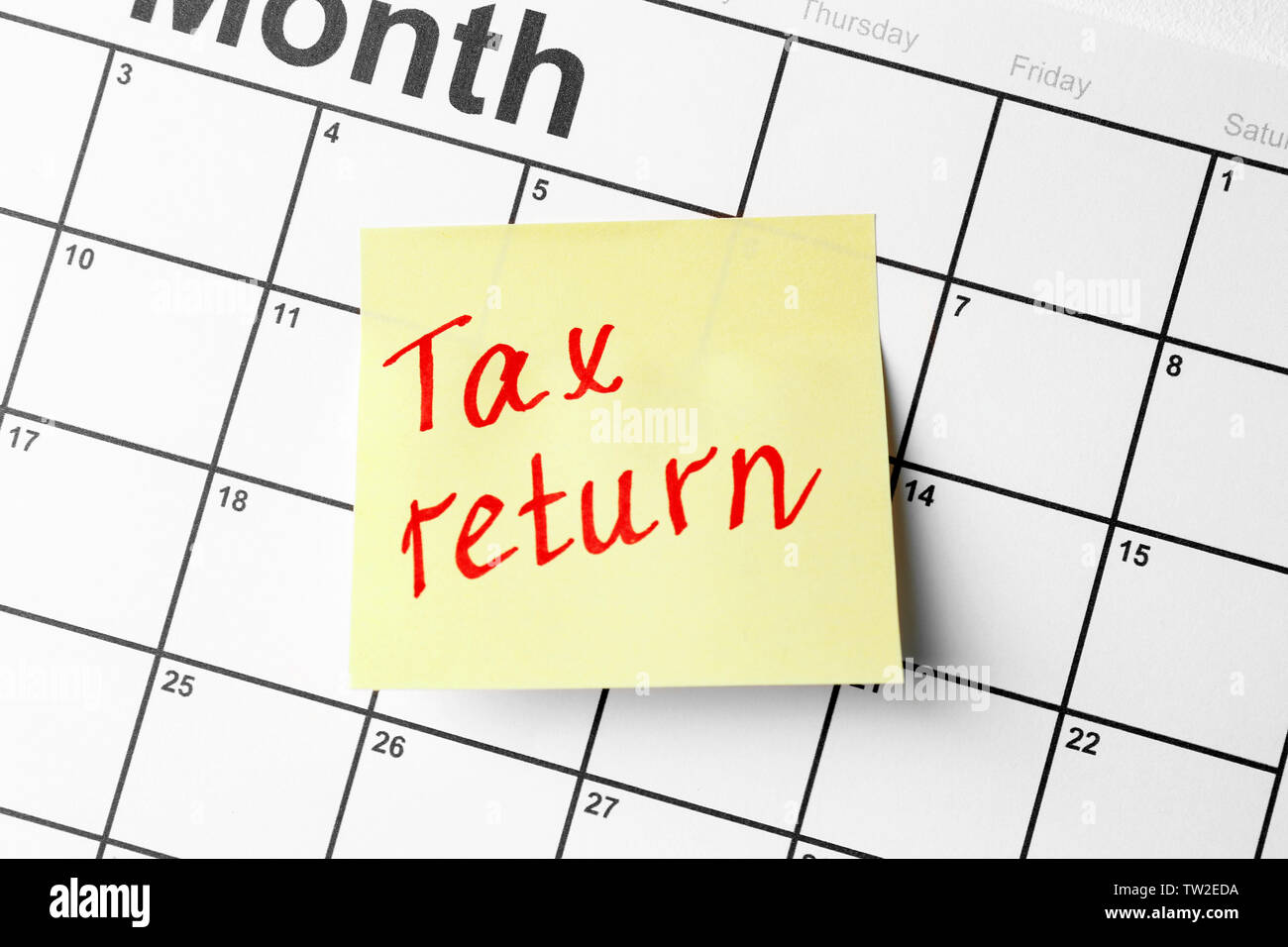Note with text and calendar. Tax return concept Stock Photo