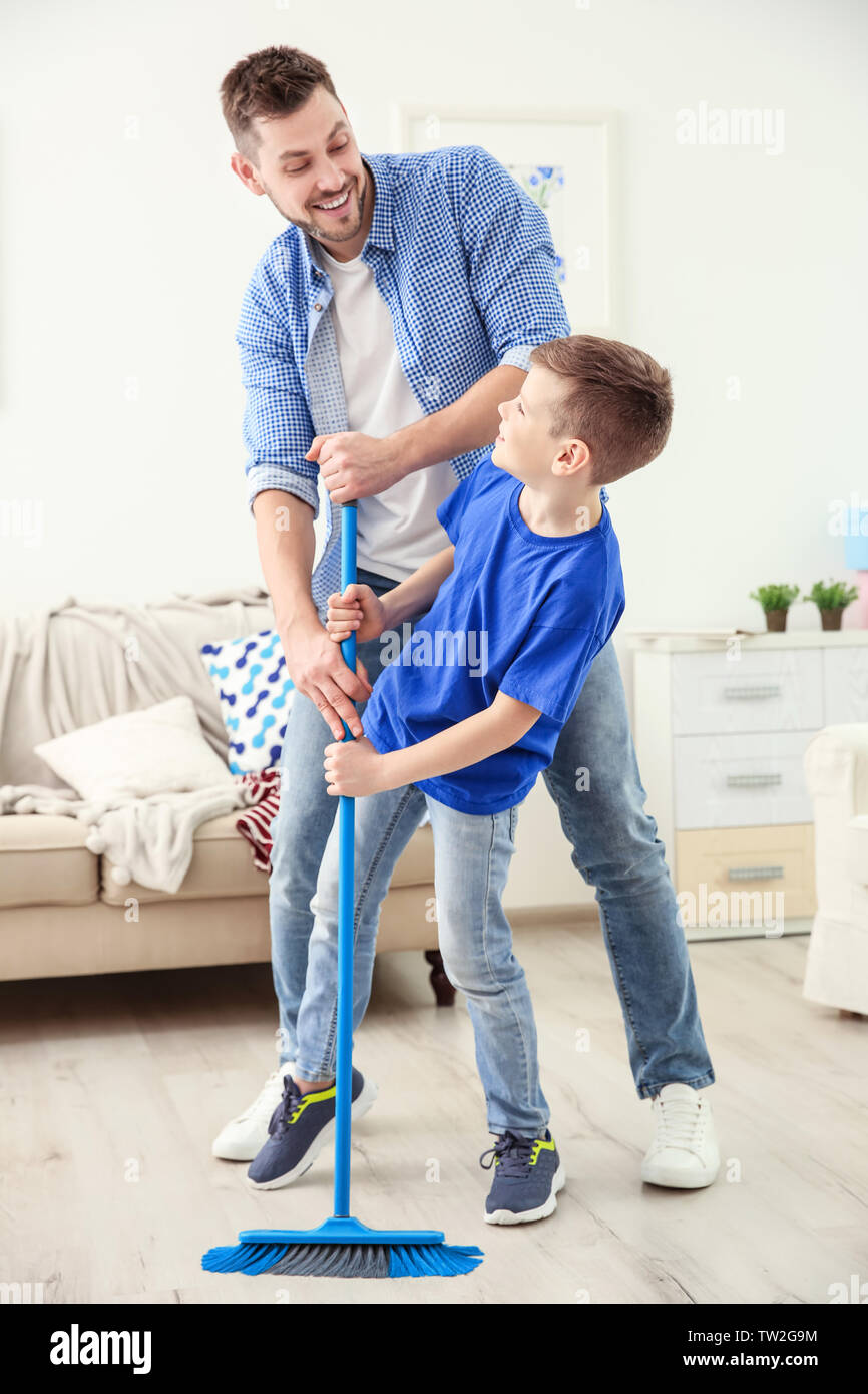 Father Boy Child Sweeping Mess Family Cleaning Together Help Broom Stock  Photo by ©PeopleImages.com 653791010