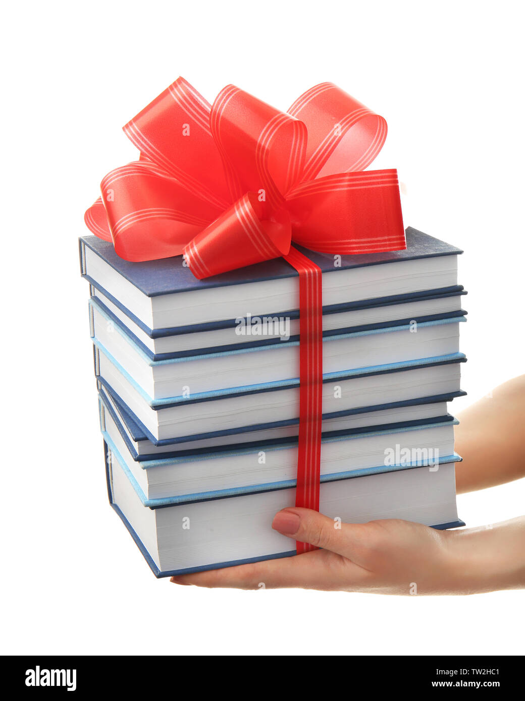 Woman holding stack of books with ribbon as gift on white background ...