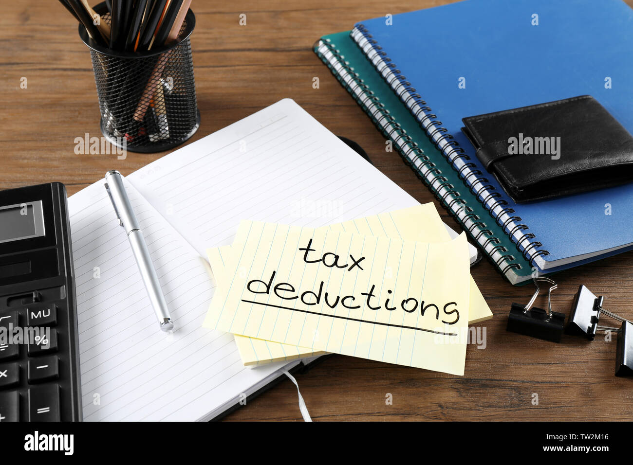 Paper Sheet With Text Tax Deductions Calculator And Open Notebook