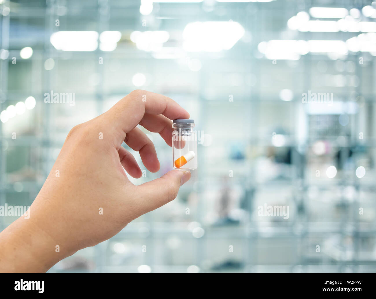 medicine pill in bottle with blur scientist lab background Stock Photo