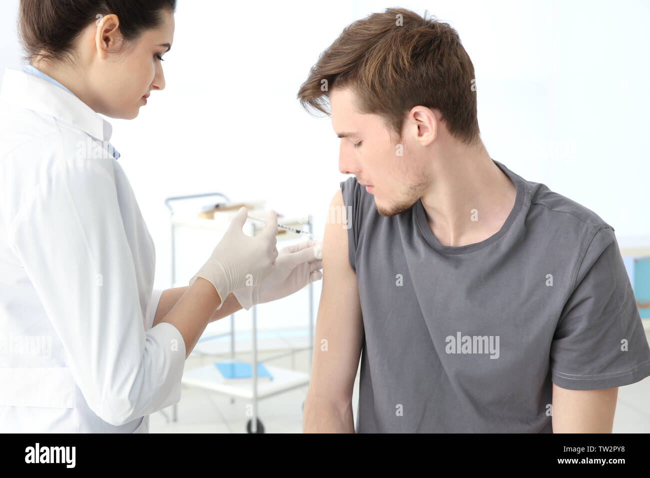 Injection in shoulder hands syringe hi-res stock photography and images ...