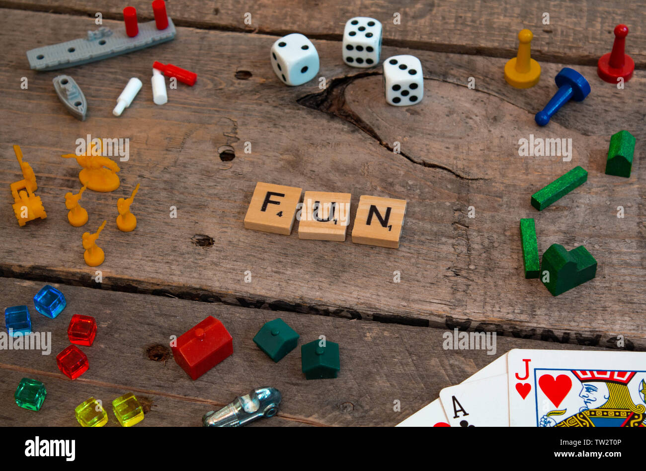 "Fun" made from Scrabble game letters, Risk, Battleship pieces, Monopoly, Settler of Catan and other game pieces Stock Photo