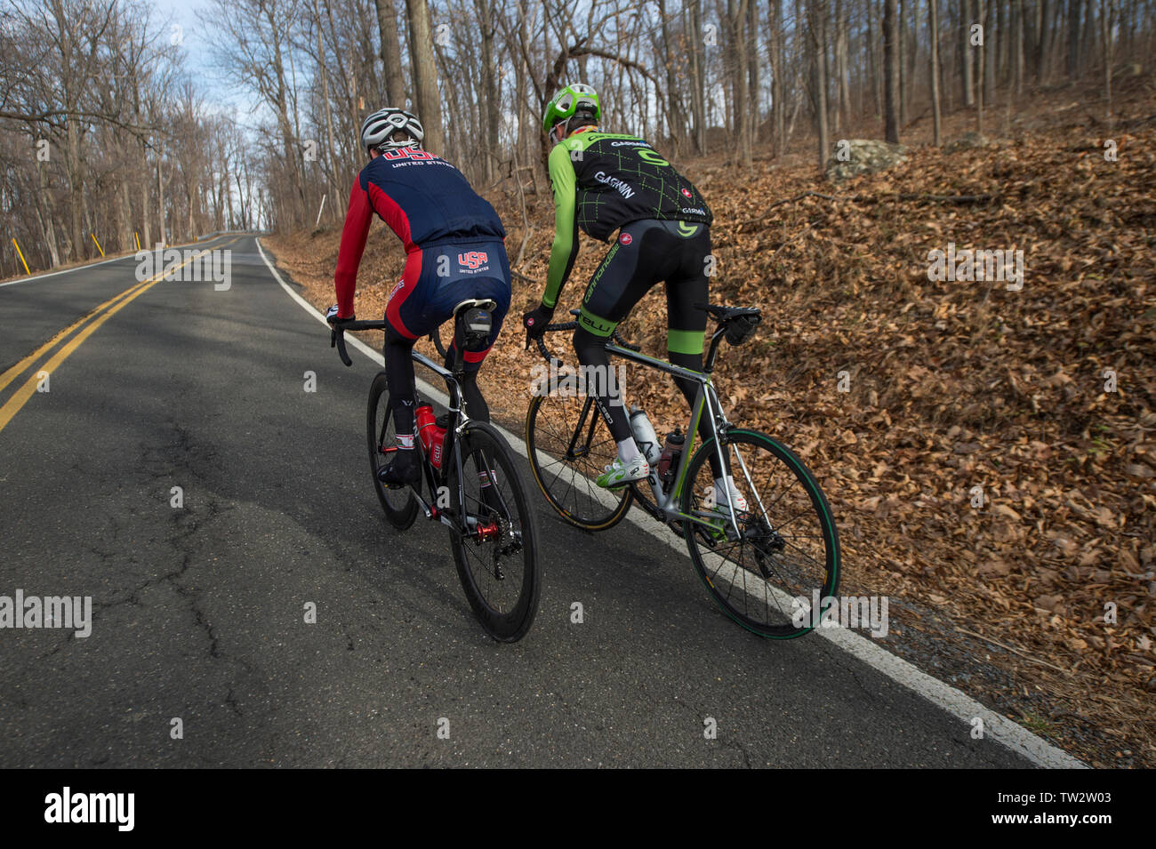 UNITED STATES - December 8, 2015: Pro cyclist Justin Mauch and Joe Dombrowski ride across Mt. Weather in the Blue Ridge Mountains of Virginia near Par Stock Photo