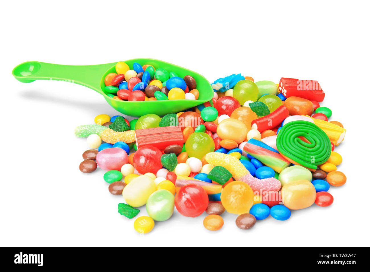 Tasty and colorful candies with scoop on white background Stock Photo ...