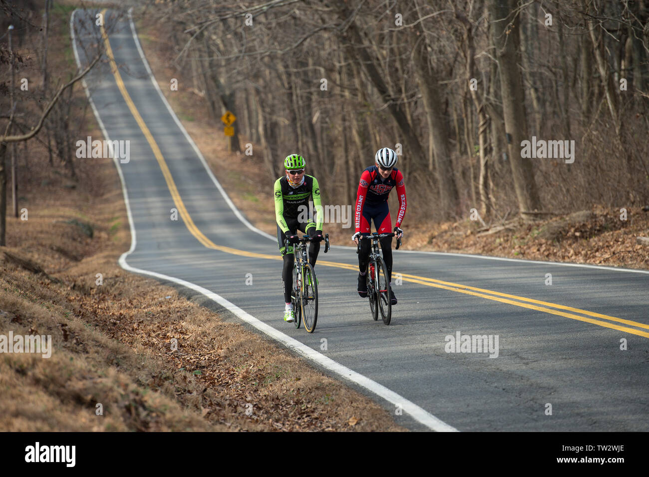 UNITED STATES - December 8, 2015: Pro cyclist Justin Mauch and Joe Dombrowski ride across Mt. Weather in the Blue Ridge Mountains of Virginia near Par Stock Photo