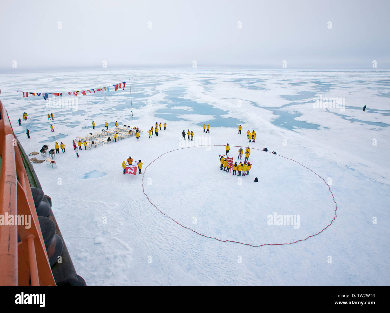 Tourists form circle at North Pole after reaching 90 degrees North on Russian nuclear icebreaker 50 Years of Victory. July 2008. Stock Photo