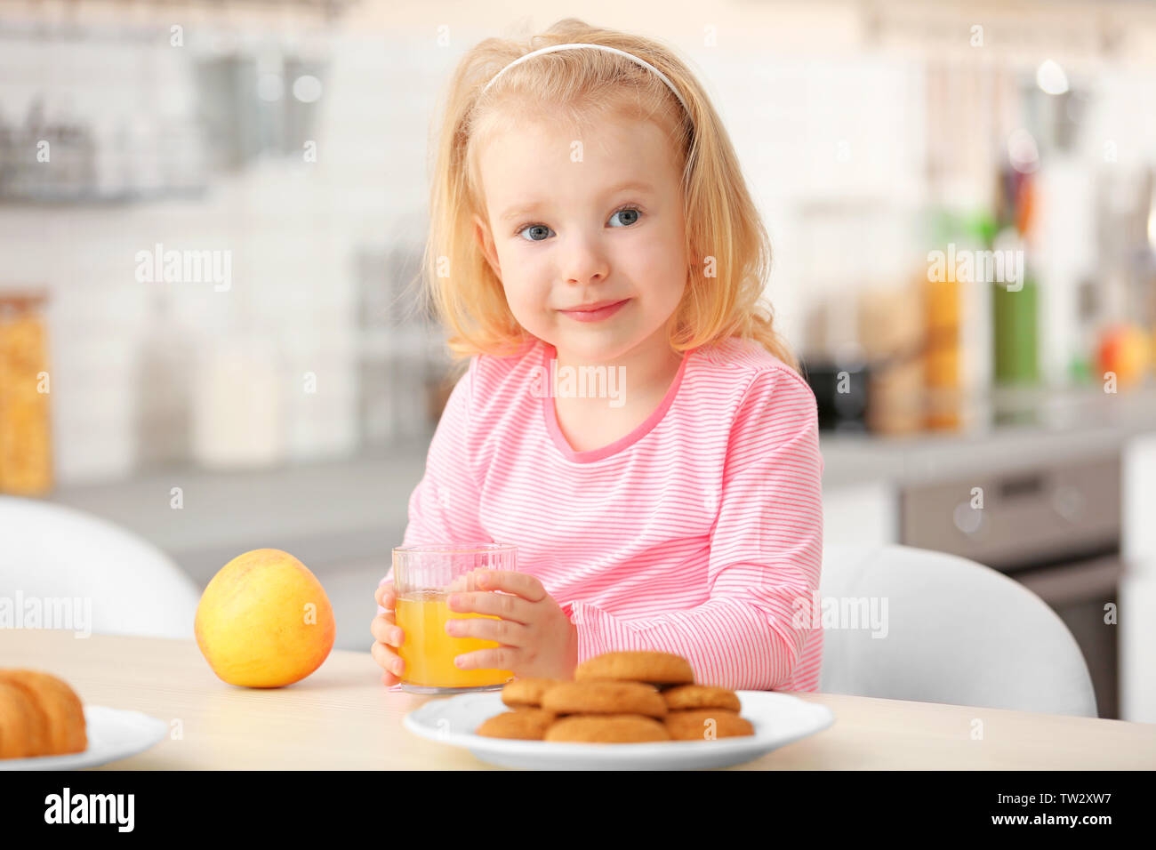 Breakfast Little Cute little girl having breakfast at home Stock Photo - Alamy