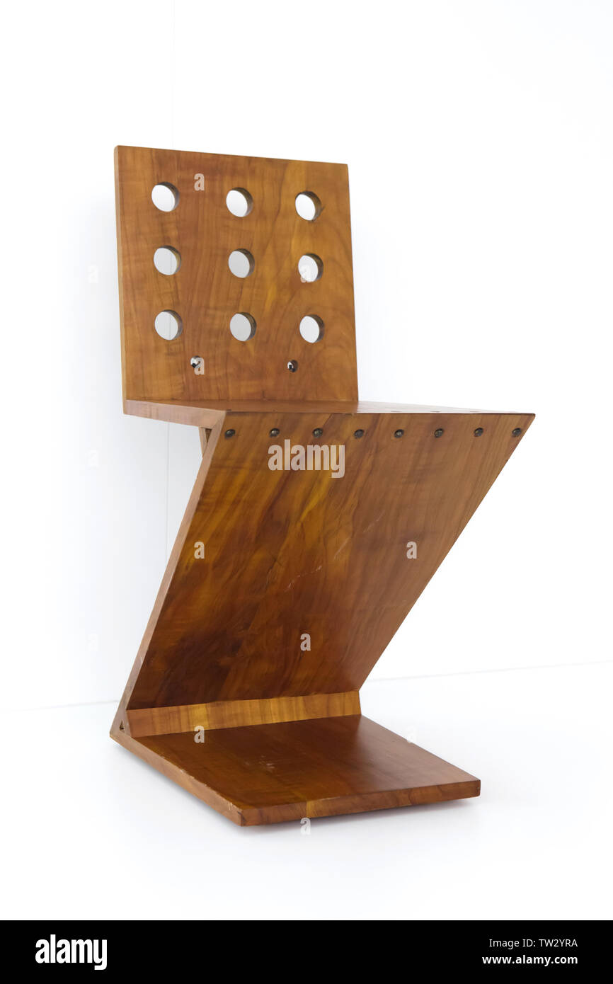 Zig-Zag Chair (1932) designed by Dutch furniture designer Gerrit Rietveld on display in the Pinakothek der Moderne in Munich, Bavaria, Germany. Stock Photo