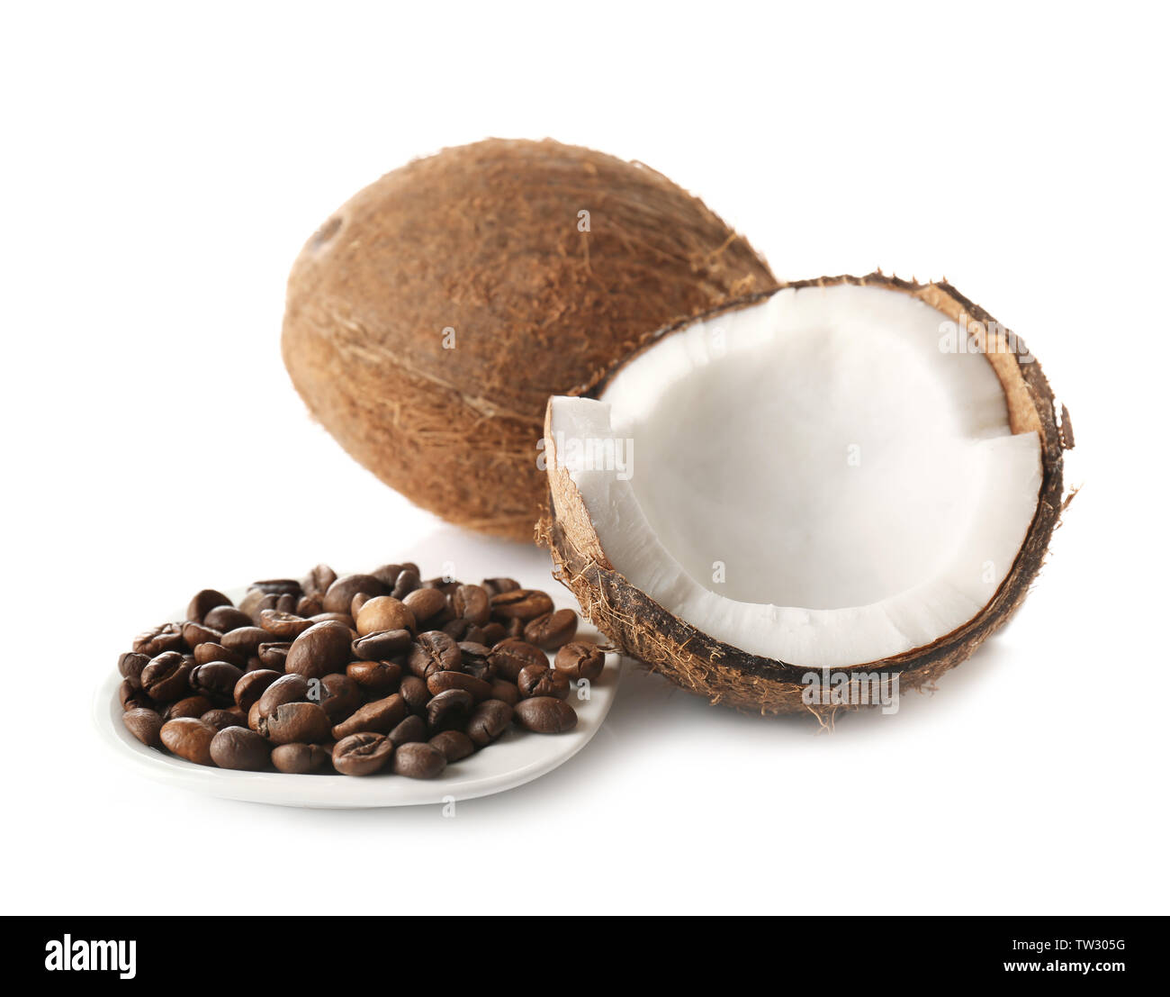 Saucer with coffee beans and coconuts on white background Stock Photo