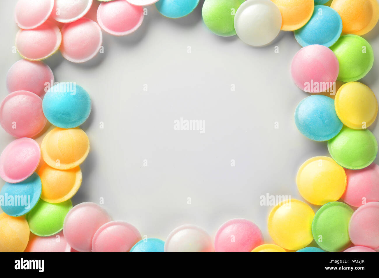 Frame made of tasty colorful candies on white background Stock Photo ...