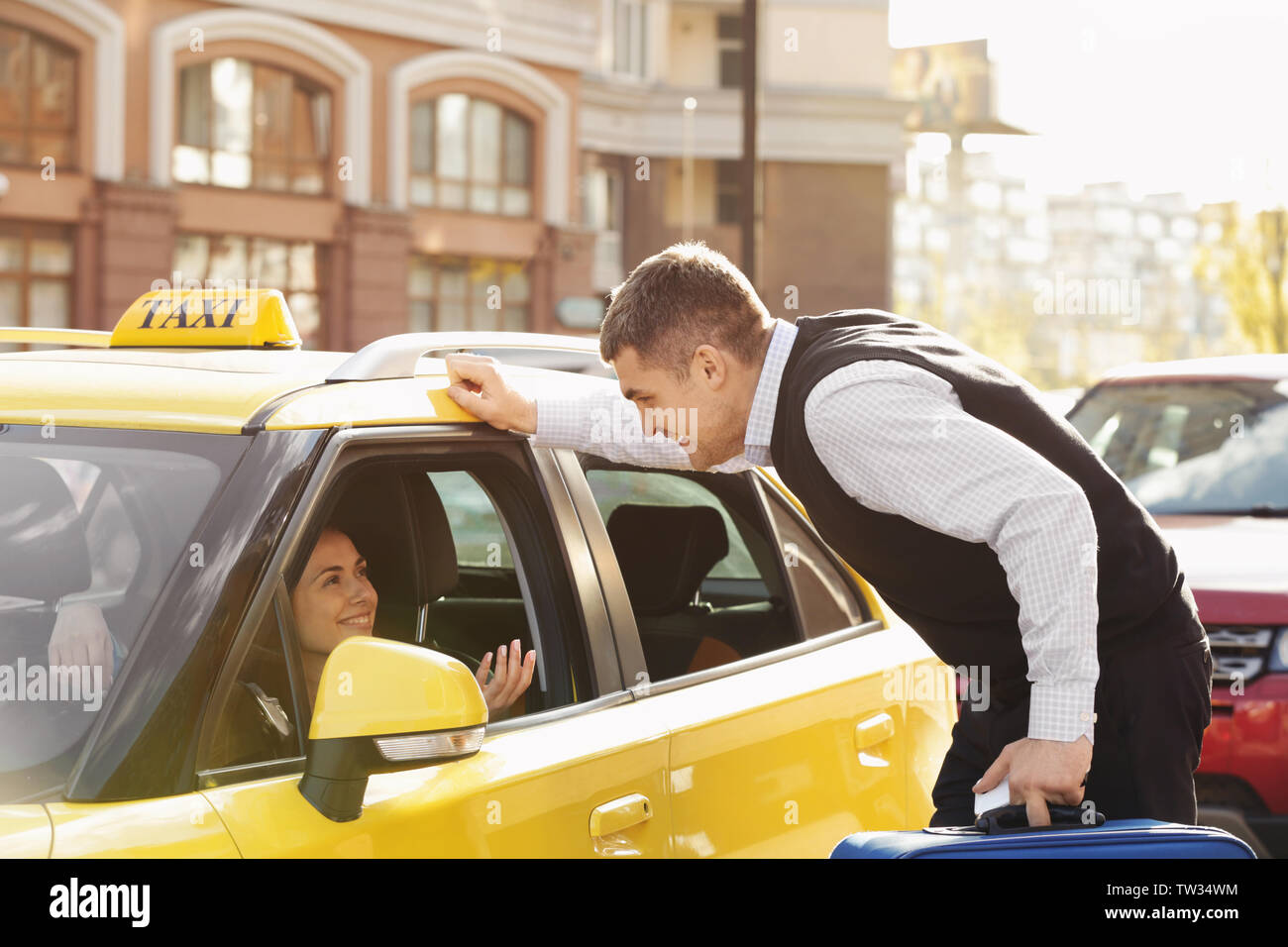 Handsome Man Talking To Female Taxi Driver Through Opened Window Stock Photo Alamy https www alamy com handsome man talking to female taxi driver through opened window image256381264 html