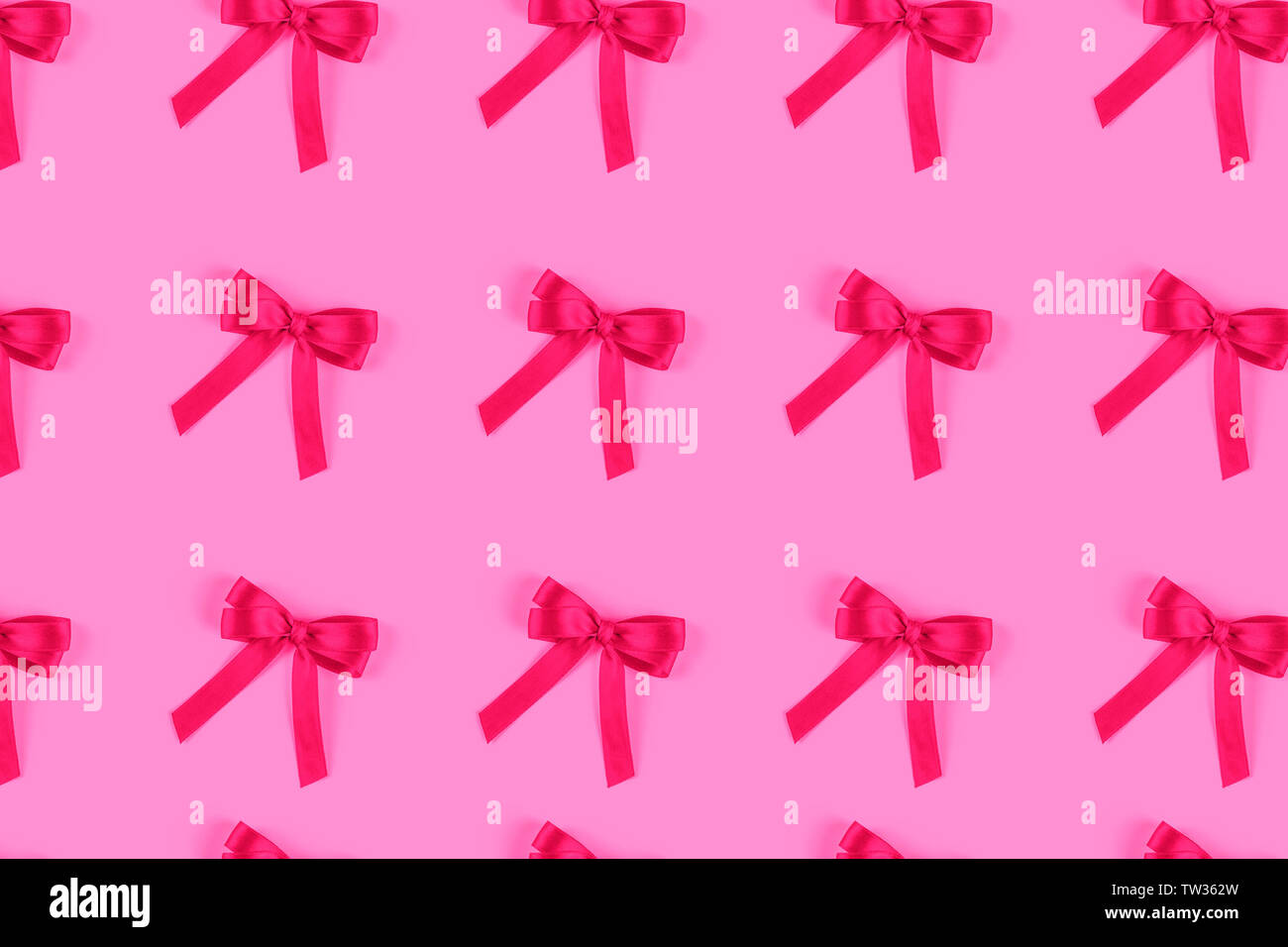 Pink silk gift bow isolated on pink. Stock Photo