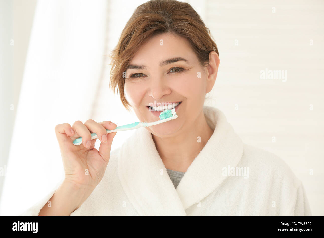 Senior woman cleaning teeth at home Stock Photo Alamy